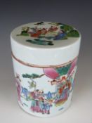 An 18thC Chinese covered canister decorated with a court scene of subjects bringing gifts, one