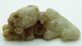 Chinese carved celadon and russet jade Dog of Fo, 2.6x7cm