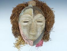 African tribal carved Bakongo mask with raffia and cloth decoration, H27cm