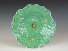 Chinese pottery dish in the form of a lily pad decorated with insects, raised on a stylised foot,