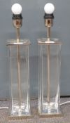 A pair of designer glass and stainless steel table lamps, probably Promemoria, H52cm