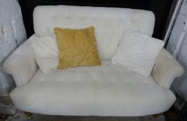 Laura Ashley cream button back two seat sofa raised on turned legs and brass castors, W146cm