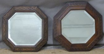 Two octagonal bevelled glass mirrors with carved oak frames including one with Greek key design,
