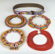 Four African tribal Samburu single layer beaded necklaces and a beaded belt, largest diameter 22cm