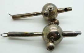 Two Chinese white metal baby's rattles with whistle, impressed Chinese marks to the handles