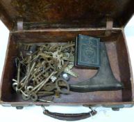 A quantity of vintage keys, voltmeter in leather suitcase
