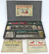 Meccano Outfit 5 with unpainted parts and black wheels, in original box with instructions.