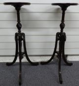 A pair of mahogany pedestal wine tables with swag decoration each raised on three legs, H84cm