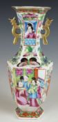 A 19th/20thC Chinese twin handled pedestal vase decorated with figures in the famille rose plate,