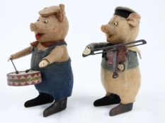 Two Schuco felt clockwork model Disney's Three Little Pigs each playing musical instruments, one