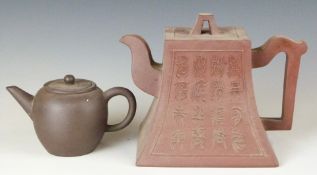 Two Chinese Yixing teapots and covers including a calligraphy example, tallest 12.5cm