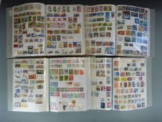 A collection of all-world stamps in four ring binders