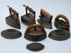 Seven sad and slug irons to include Kenrick, Sensible N.R.S.S Co., asbestos sad iron and one with