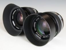 Two Olympus OM-system Zuiko lenses, one Auto-S 50mm 1:1.4 the other Auto-W 35mm 1:2