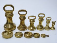 Six brass bell weights, some with Victorian VR cypher, from 14lb downwards, together with six