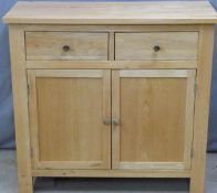 Modern light oak or similar sideboard two drawers above cupboards and cupboards and drawers to the