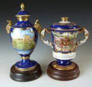 Two limited edition covered pedestal commemorative urns by Aynsley and Caverswell, exclusive to