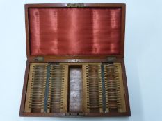 Cased set of optician's or similar lenses, one side labelled convex the other concave, width of case