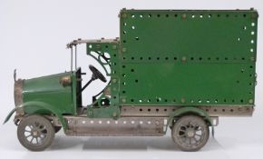 Meccano or Butcher & Sons Primus model of a lorry made using green and unpainted parts, 38cm long.