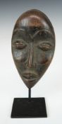 African tribal carved passport / miniature mask on bespoke stand, Liberia, probably early 20thC,
