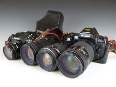 Two Nikon SLR cameras comprising F-501 and F-801, with four Nikon lenses, comprising 24mm 1:2.8,