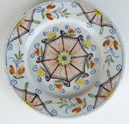 An 18thC London Delft plate with a geometric polychrome decoration, diameter 22cm
