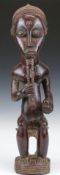 African tribal Baule carved figure with braided beard seated on a stool, H51cm. Provenance:- part of
