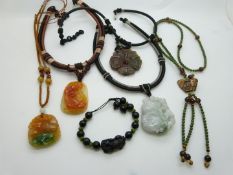 A nephrite jade and tiger's eye necklace, an agate pendant, and a Chinese hardstone bracelet