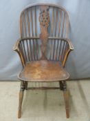 A 19thC elm seated Windsor armchair with hoop back