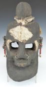 African tribal carved wood mask with multiple piercings and shell earrings, H35cm