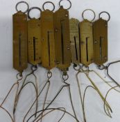 Seven Victorian and later Salter postage or letter spring balances, all with wire letter racks and
