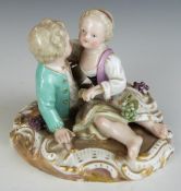 Meissen figure of sweethearts embracing, with applied grape and vine decoration, blue crossed swords