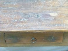 Rustic farmhouse style side table with single drawer below a two plank top, raised on square