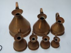 Set of seven copper measuring jugs from 1 gallon down to ½ gill, height of tallest 29cm