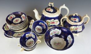 An early 19thC tea set, hand decorated with flowers in the Gaudy Welsh style, probably Rockingham,