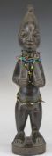 African tribal Yoruba carved fertility figure with 19thC Venetian chevron bead necklace, H31cm