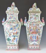 A pair of 19thC Chinese famille rose covered vases with twin figures to each handle and female