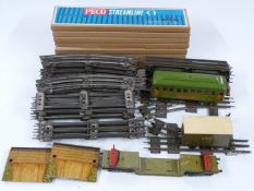 A collection of 0 gauge model railway rolling stock, accessories and track including Lionel