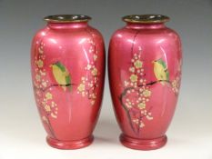 A pair of Japanese lacquered / enamelled vases decorated with birds and prunus blossom, printed