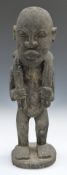 African tribal carved figure carrying dead game, H39cm