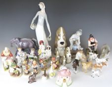 A large collection of ceramic figures including Staffordshire, Lladro, Goebel Hummels, Beswick,