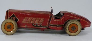 Mettoy clockwork tinplate racing car with red body, white 'Dunlop Fort' tyres and raving number 7,