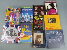 Beatles memorabilia including books, DVD, puzzles and newspapers