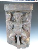 An 18th/19thC carved wood Indian figural temple piece depicting a Hindu deity/god, W71 x D16 x