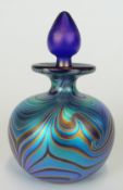 Okra iridescent glass scent bottle with pulled feather decoration over a cobalt blue ground, 10.