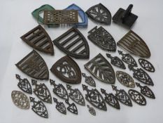 Approximately 30 flat iron stands to include many miniature examples, names include Salter, Kenrick,