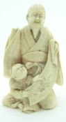 Japanese Meiji period ivory okimono of a bearded elder with child, H8.5cm