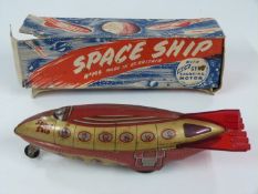 Wells Brimtoy friction powered tinplate Space Ship with gyro sparking motor, 194, in original box.