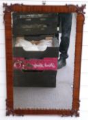 A walnut framed mirror with moulded decorative frame, 84x55cm