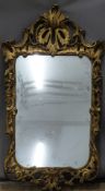 An ornate gilt framed mirror, 87x44cm